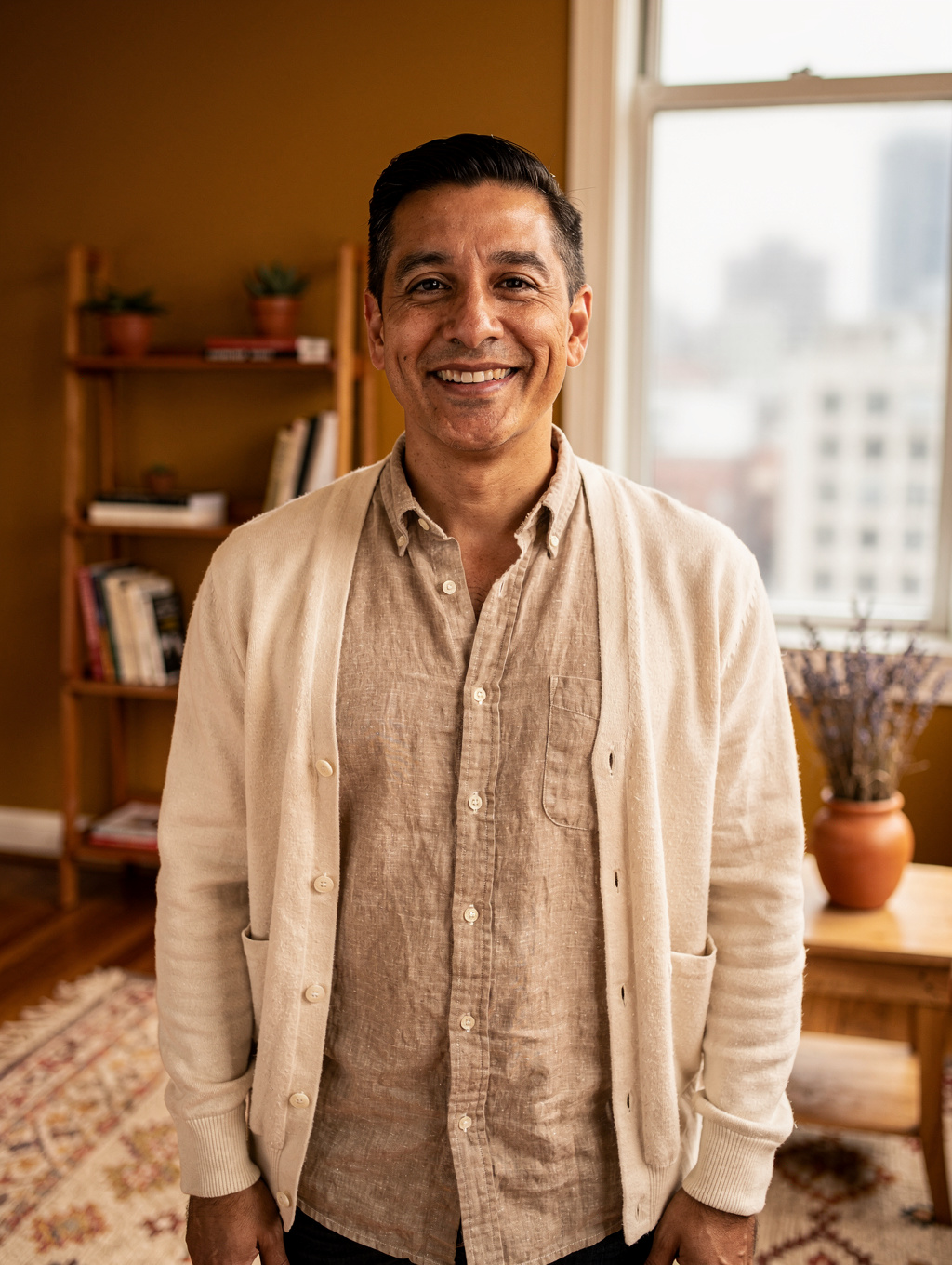 Alex Rivera, licensed therapist, smiling warmly in a sunlit San Francisco therapy office